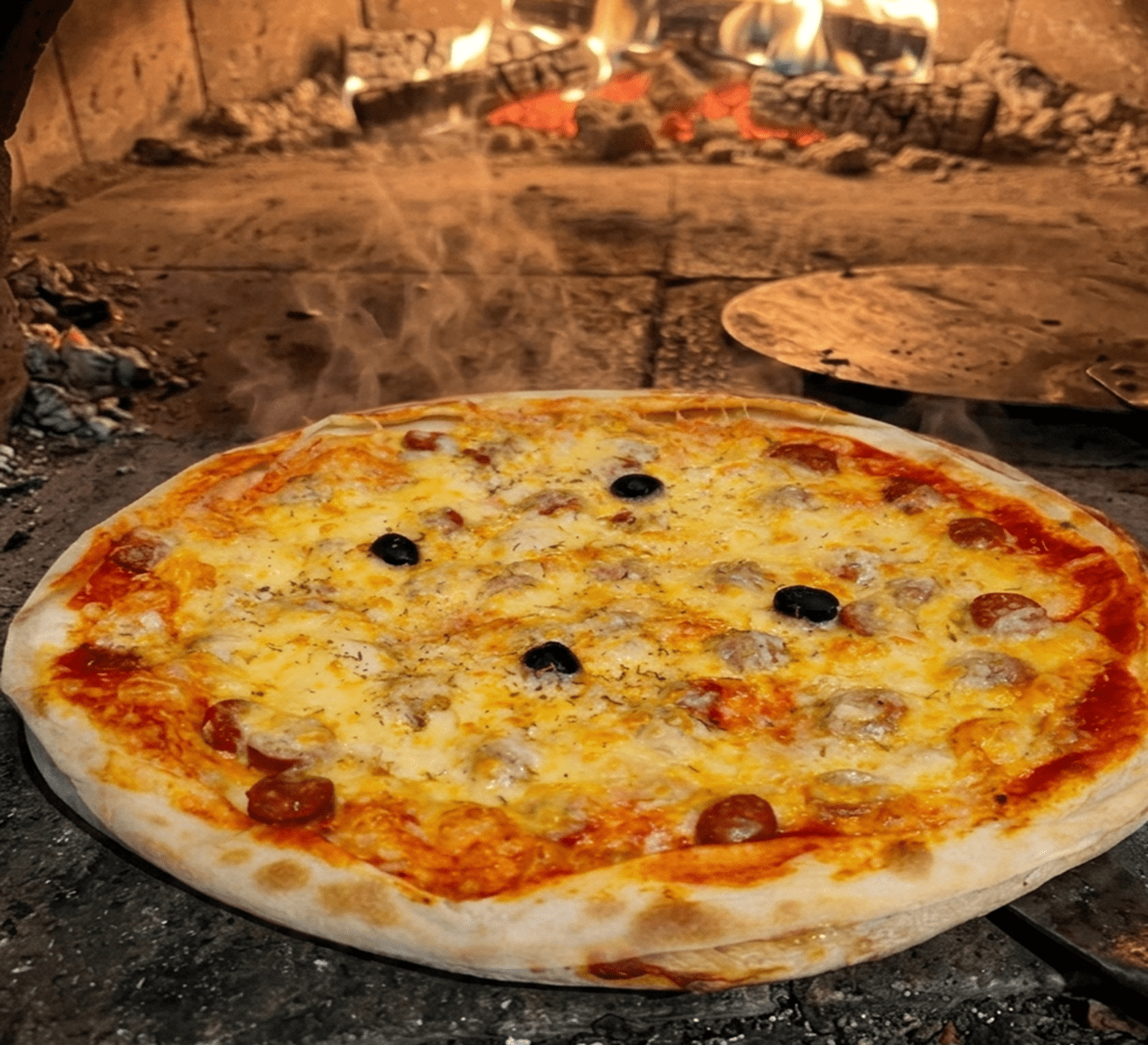 Pizzas aux viandes au feu de bois — merguez, chorizo, magret — Pizza Vroum Castres